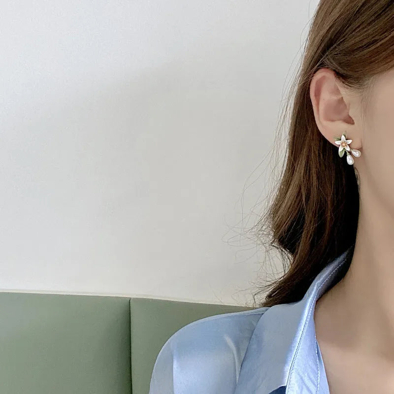 Alloy flower ear stud and matching clip-on earring pair with sterling silver needle camellia design.