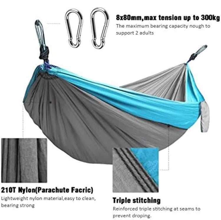 Large blue outdoor hammock made from parachute nylon fabric hanging between trees