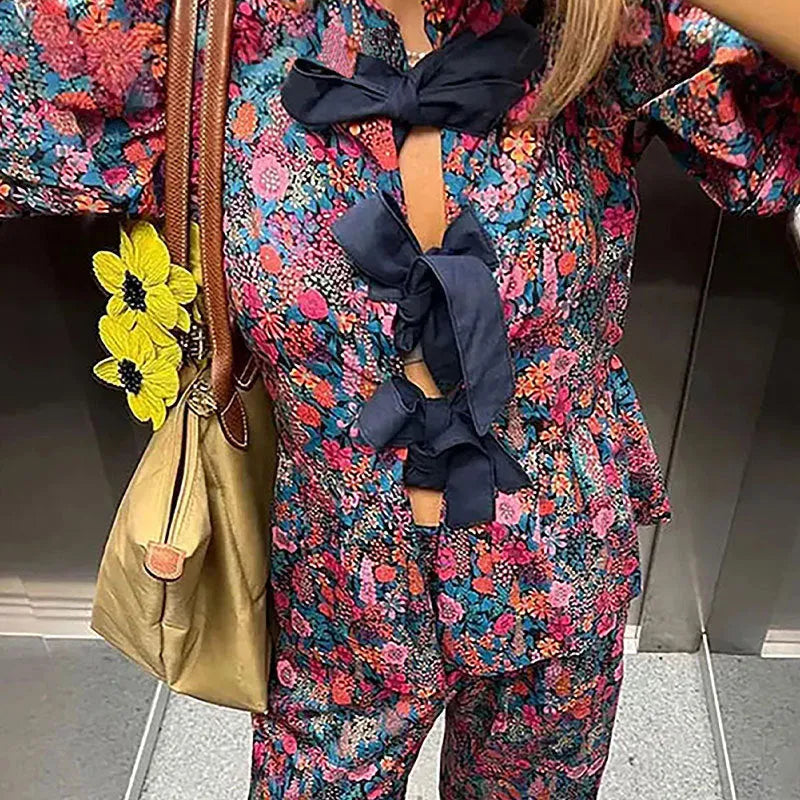 Leisure floral printed tie-neck trousers suit with puff sleeves, shown in picture colour.