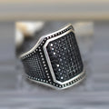 Black alloy ring with copper inlaid zircon detailing showing front view on neutral background
