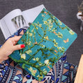 Liquid silicone flip cover case for iPad on a table, showing floral design and closed flap.
