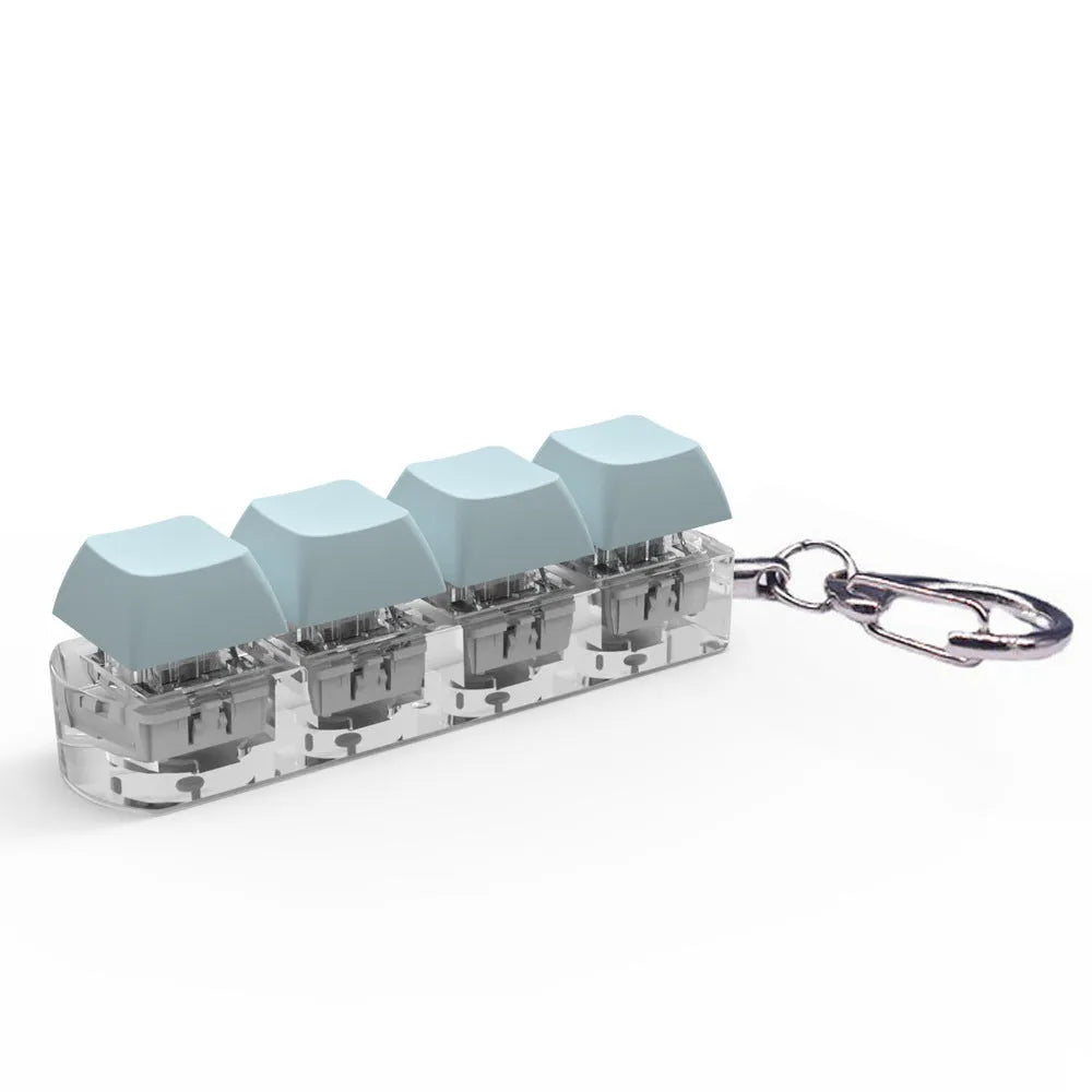 Compact 4-key mechanical keyboard switch tester on a desk, showing coloured ABS plastic construction.