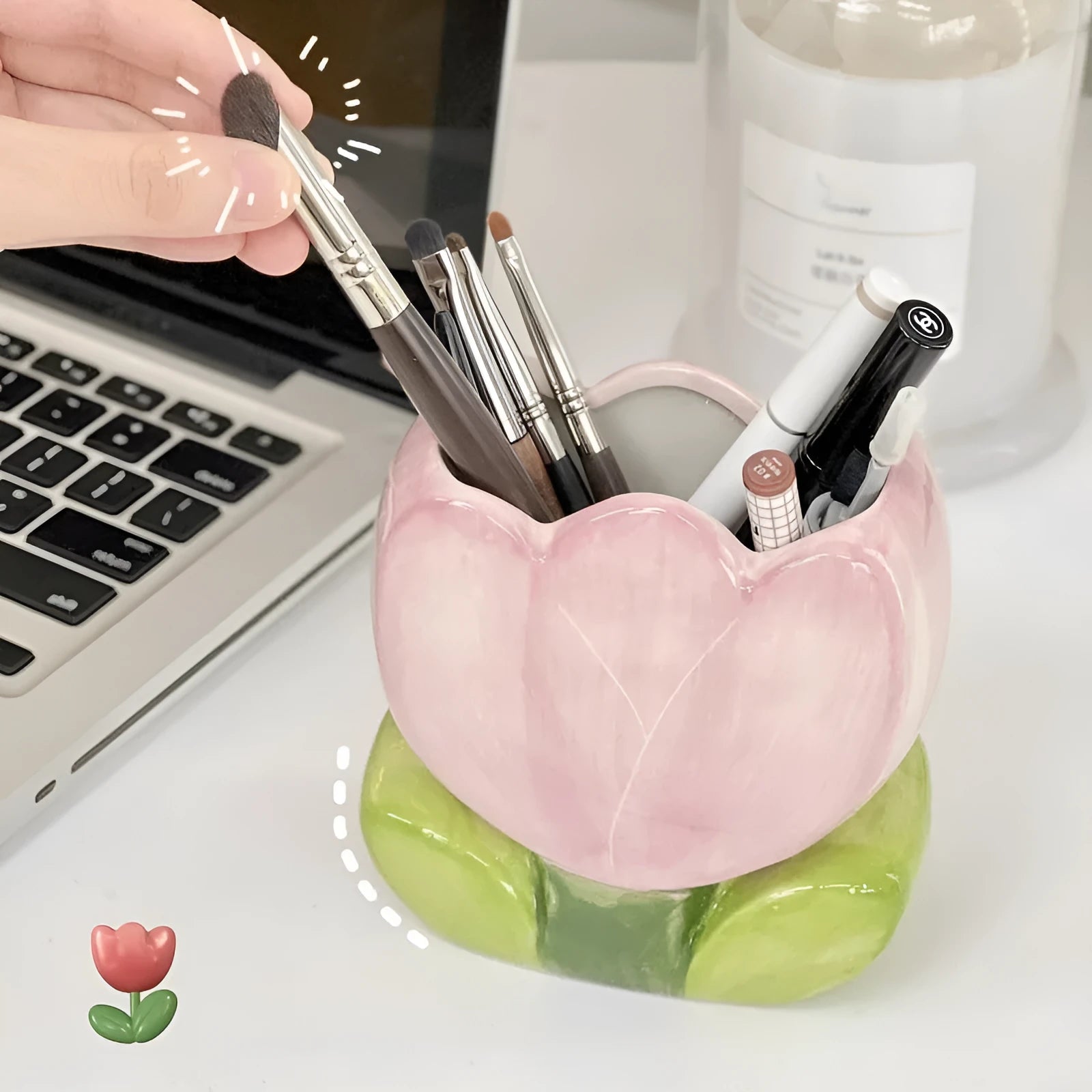 Ceramic pen holder storage box with floral decoration on desk.