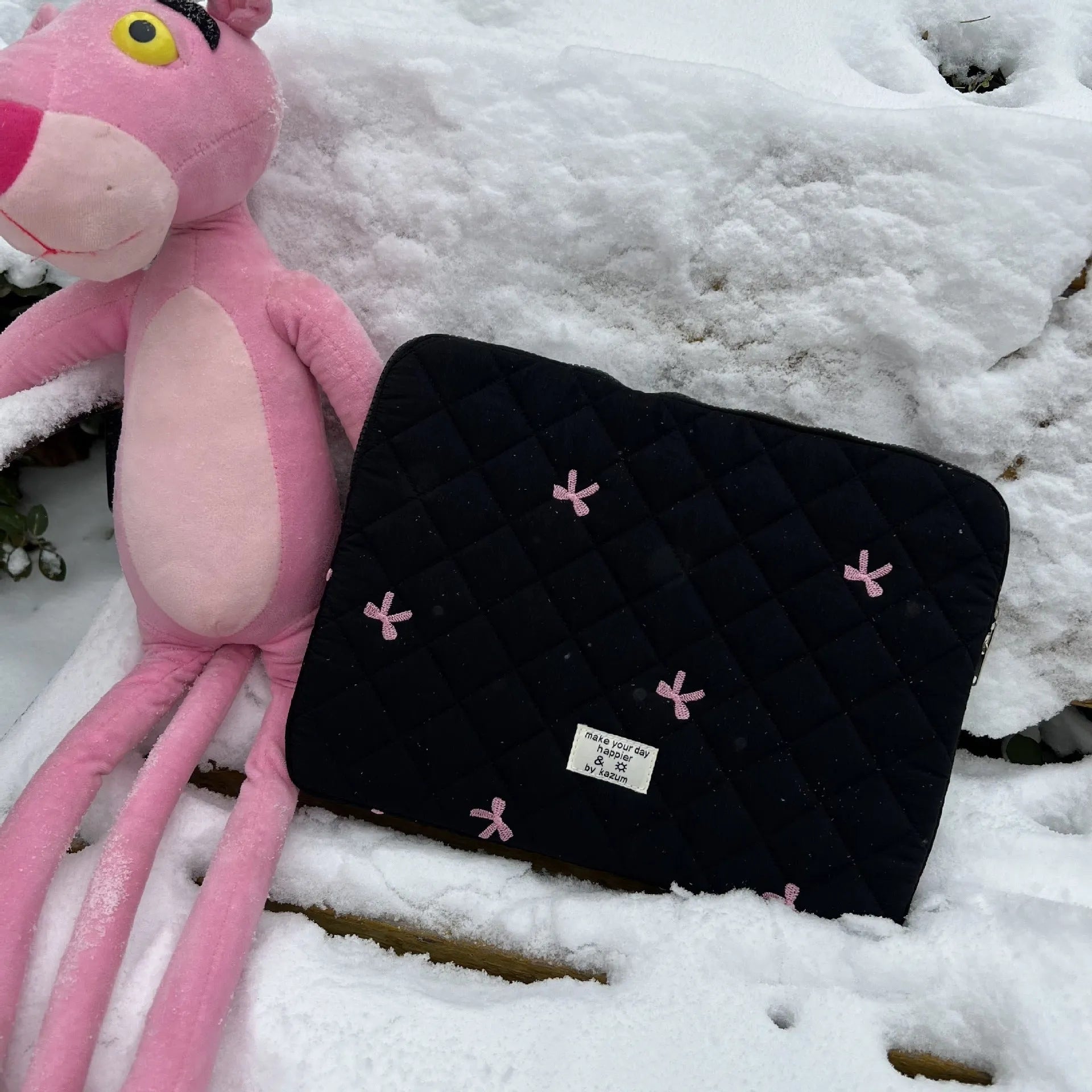Nylon laptop storage bag with embroidered rhombus and bow design in light blue.