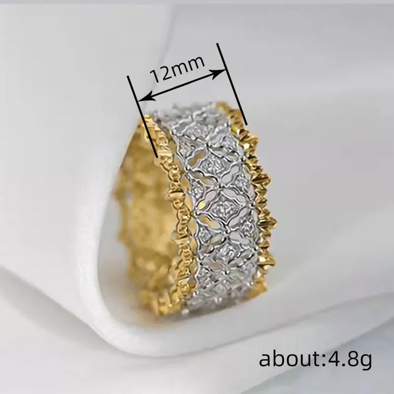 Geometric two-tone copper ring with a round zircon stone, shown on a finger.