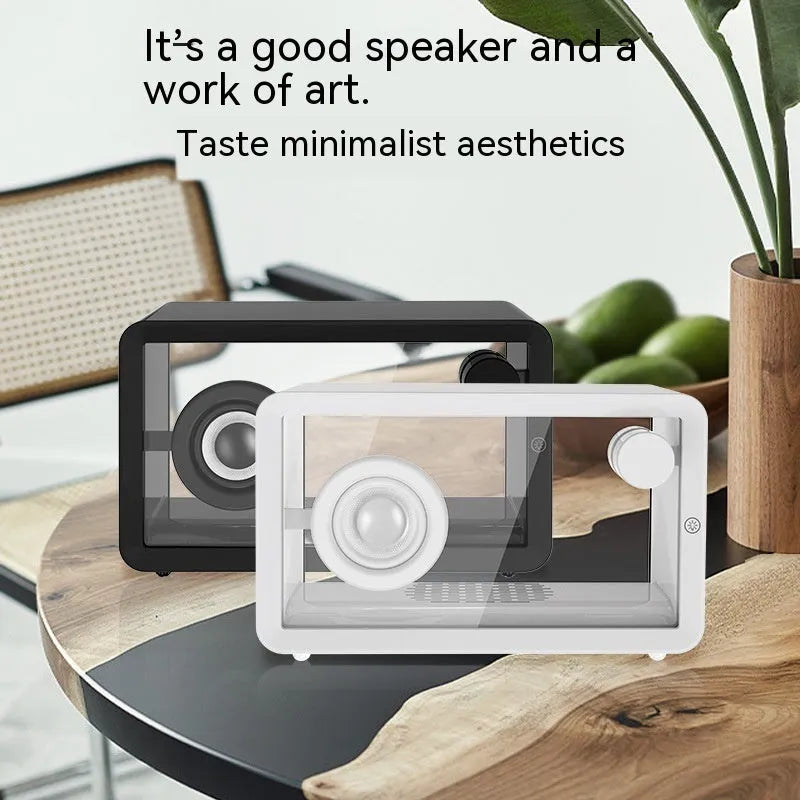 Transparent glass creative Bluetooth speaker in black on a desk with USB cable nearby