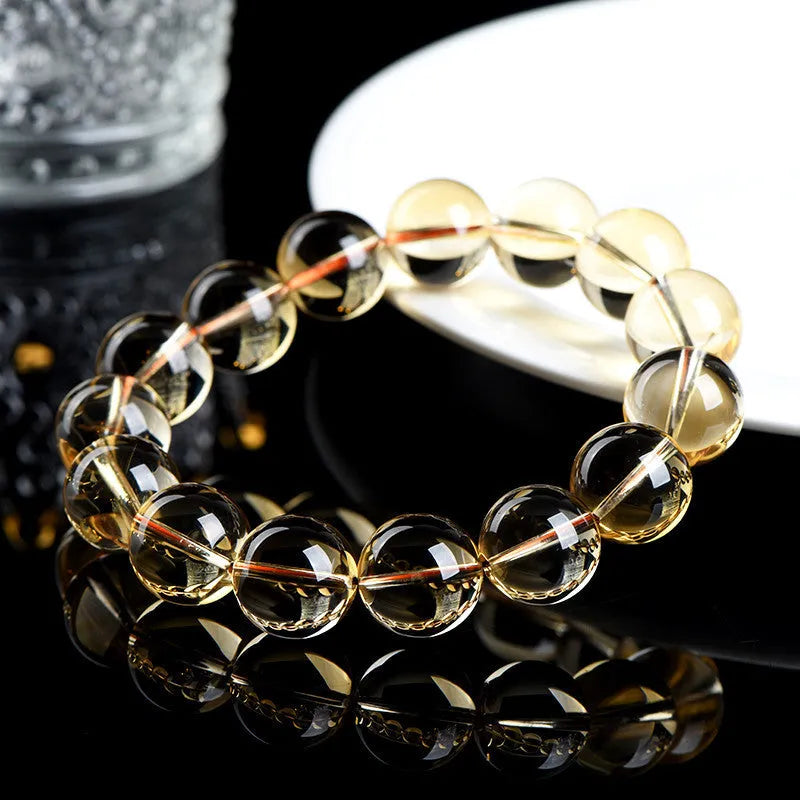 Natural citrine scattered beads bracelet showing polished gemstones in an original design on a wrist.