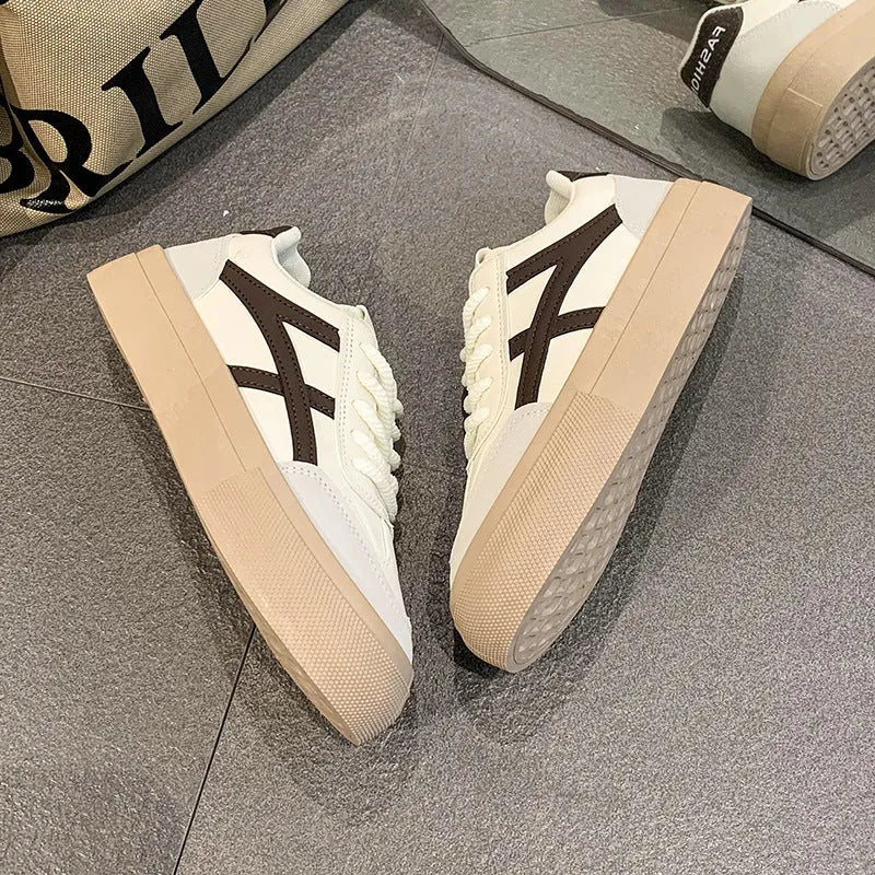 Classic brown and blue low-top casual trainers with flat rubber sole and lace-up front.