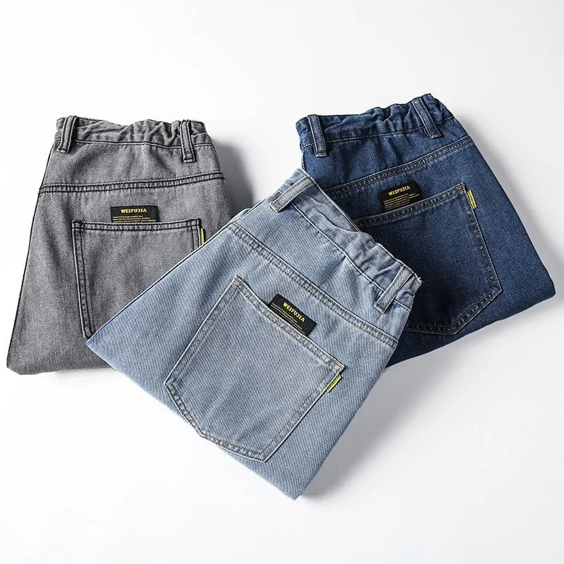 Men's loose straight-leg casual jeans in dark blue cotton on a hanger.
