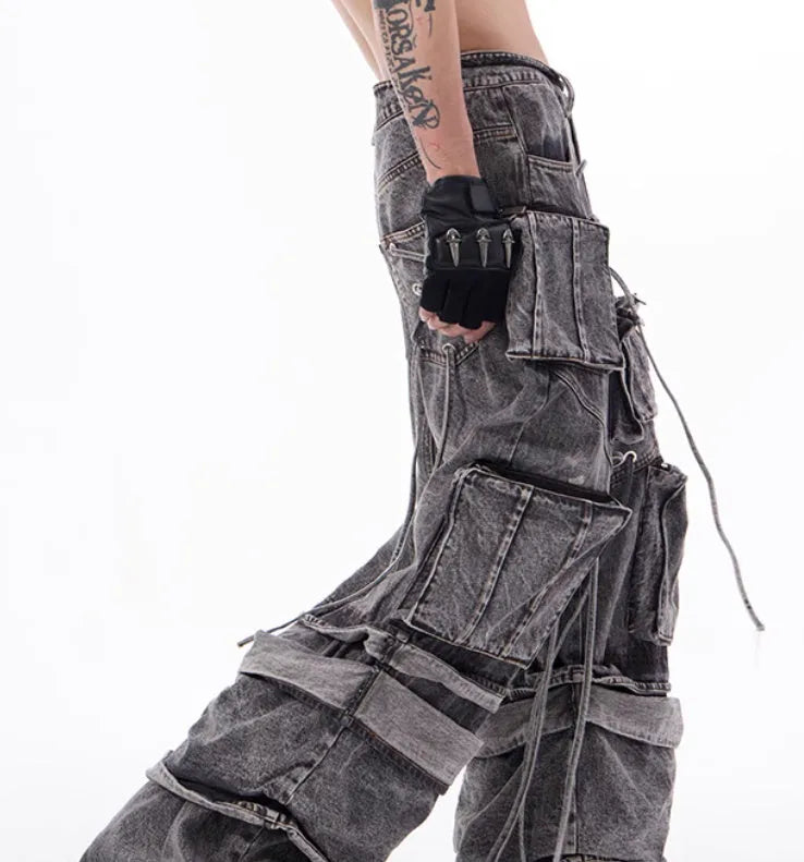 Grey denim distressed overalls with rope stitching and a wide-leg mop pants silhouette.