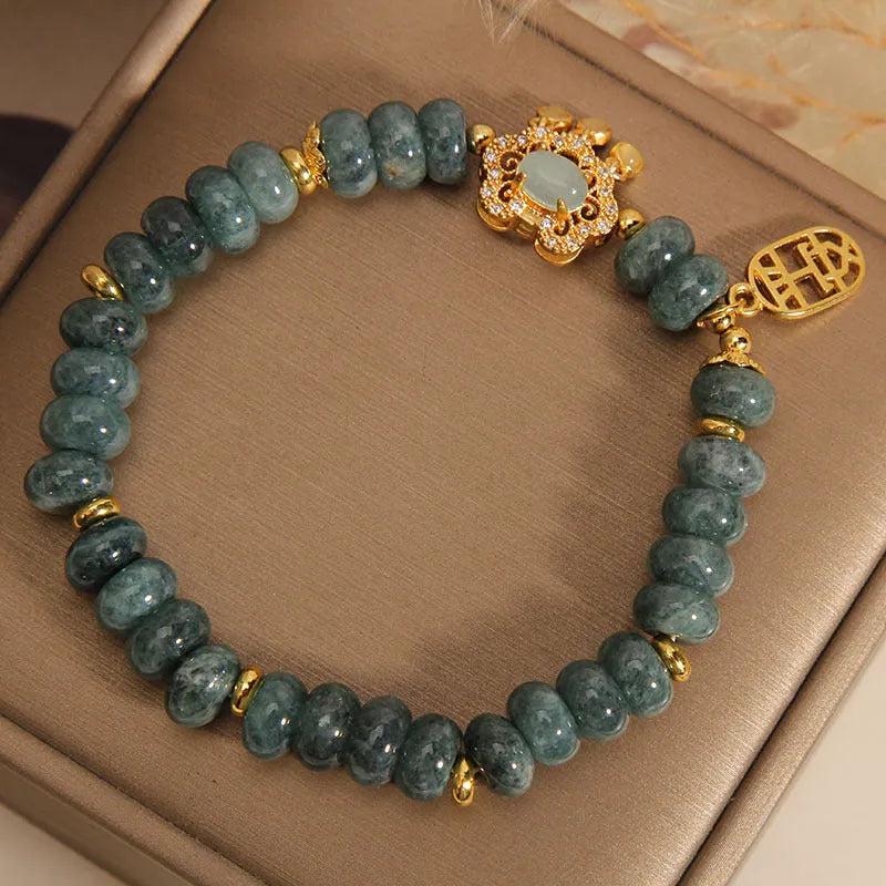 Women's natural emerald jade bracelet with alloy construction showing abacus bead design and safety lock closure