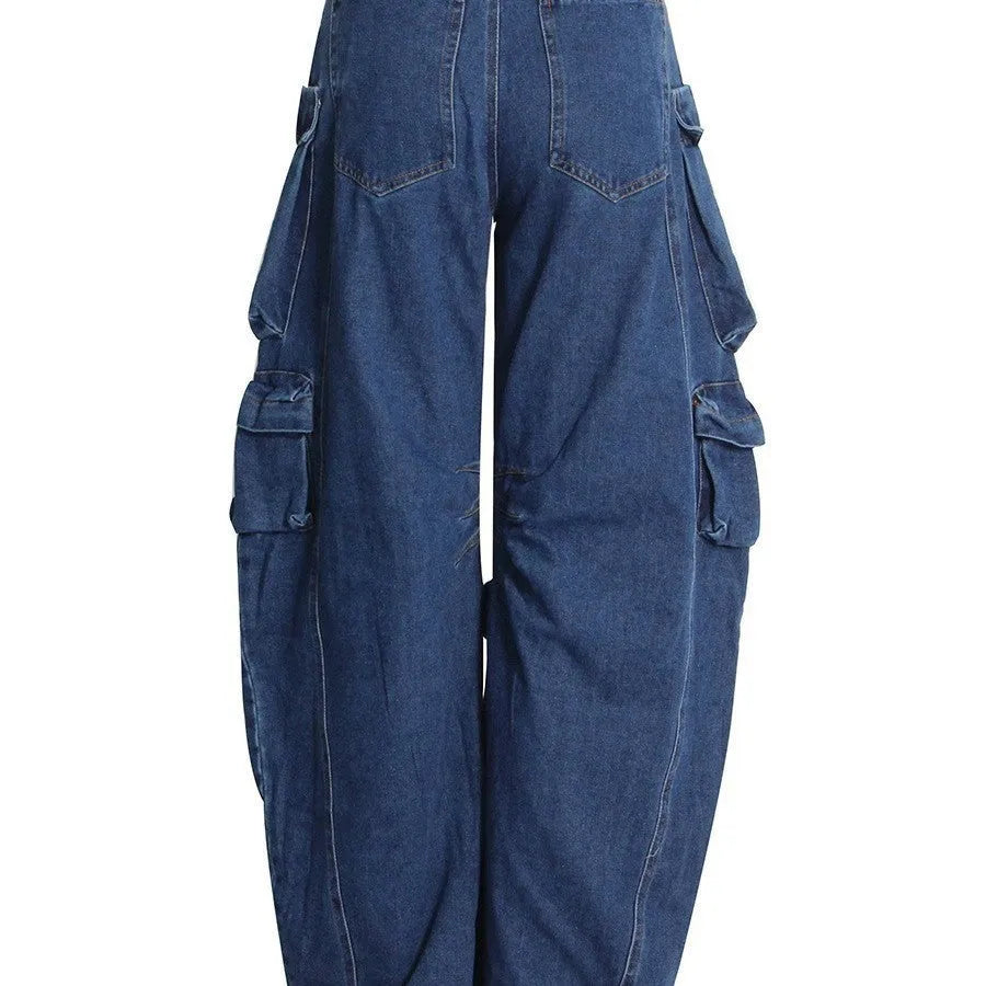 Distressed dark blue wide-leg jeans with high waist and multiple pockets on mannequin