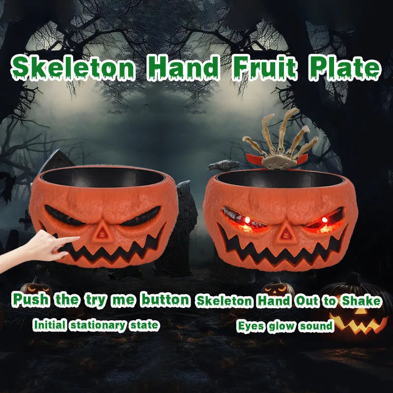 Plastic Halloween candy bowl with motion-activated skeleton hand and glowing red eyes on a table
