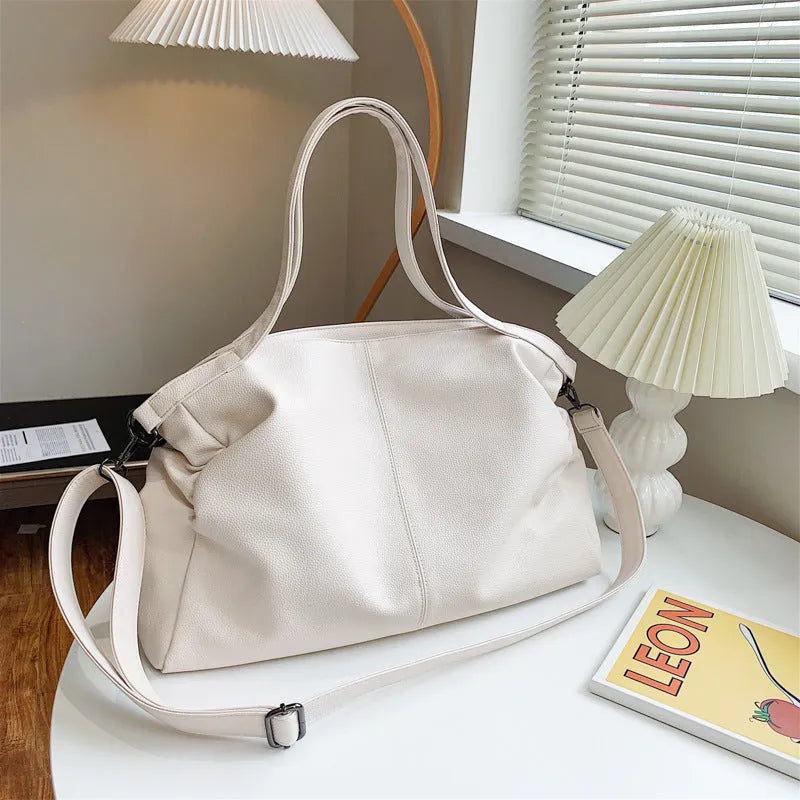 Large horizontal PU messenger bag with soft surface and shoulder strap in black colour