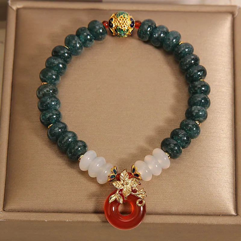 Women's crystal bracelet with blue water jade and red agate beads featuring safety buckle closure