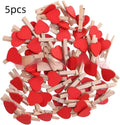 Set of five handmade solid wood heart-shaped clips in red, pink, white, and yellow on a wooden surface.