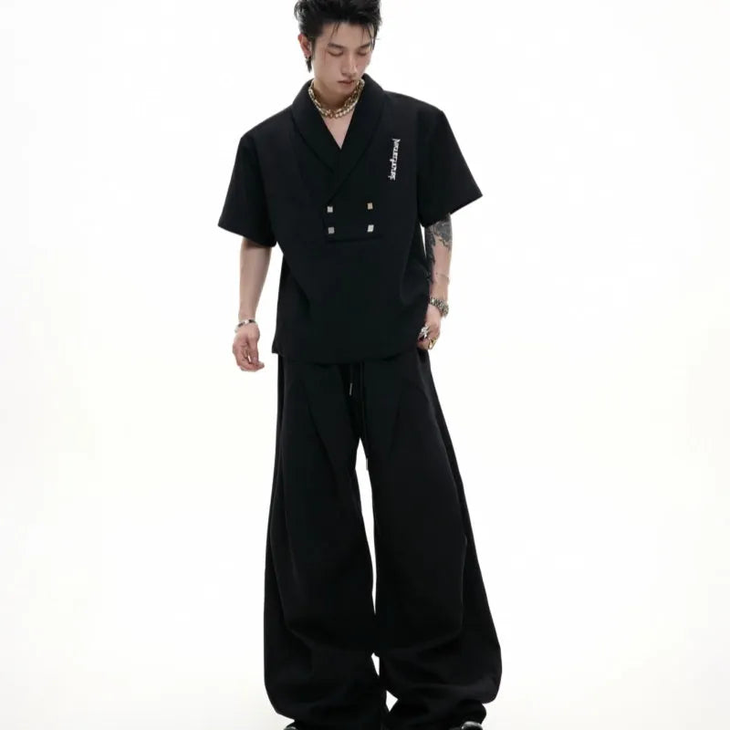 Men's dark grey cotton sports suit with metal-embellished V-neck jacket and matching shorts.