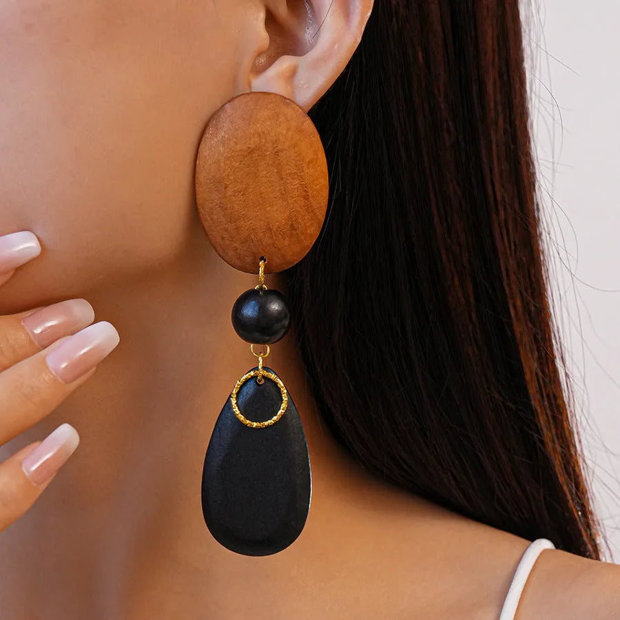 Brown-black wooden retro earrings with elliptical design and silver needle details