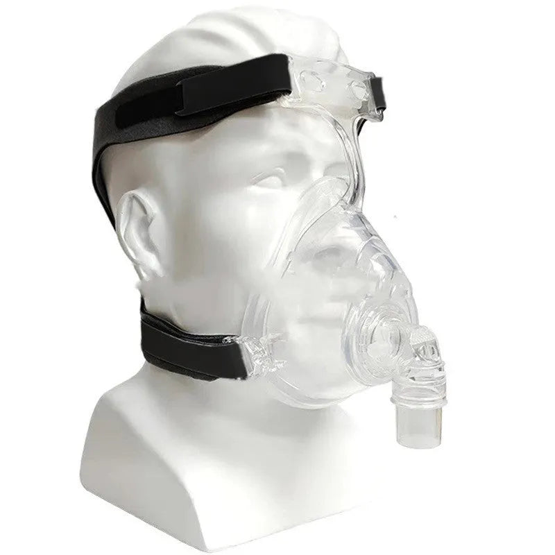 Transparent CPAP breathing mask with silicone seal, headgear, and two polycarbonate adapter elbows for ventilator connection.