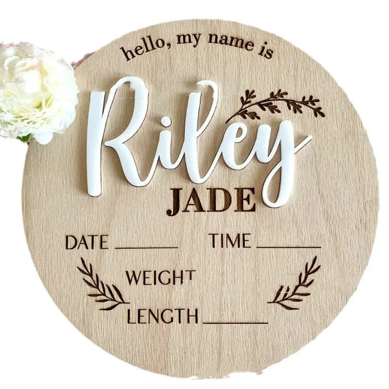 Square wooden newborn name label with baby birth information displayed on plywood