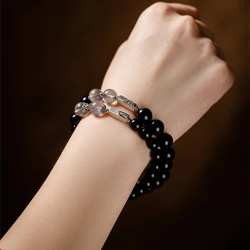 Obsidian couple bracelet DIY kit with 8mm and 10mm black beads and cord for assembly.