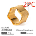 Stainless steel wide band ring with a geometric wave pattern in a metallic finish.