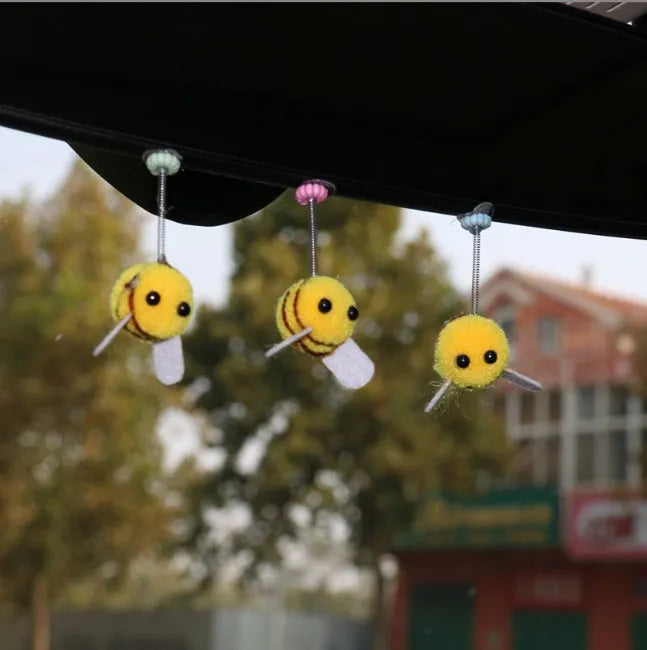 Soft fur bee car decoration on a swing spring for dashboard personalisation.