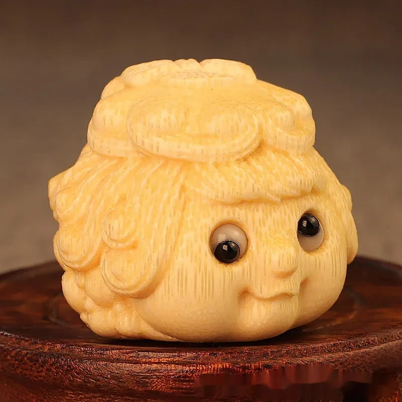 Solid bamboo carved golden toad princess ornament on display.