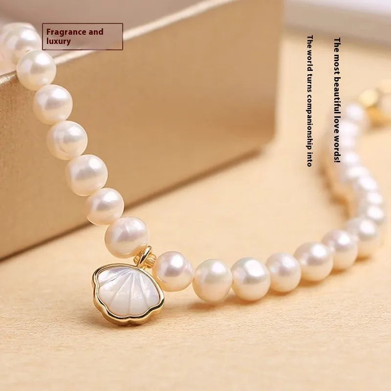 Women's freshwater pearl bracelet with fan-shaped alloy shell and choice of elastic or chain closure