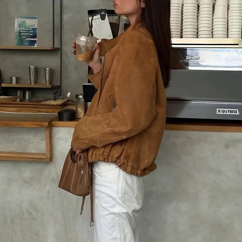 Retro-style loose-fit solid colour jacket with long sleeves on a hanger.