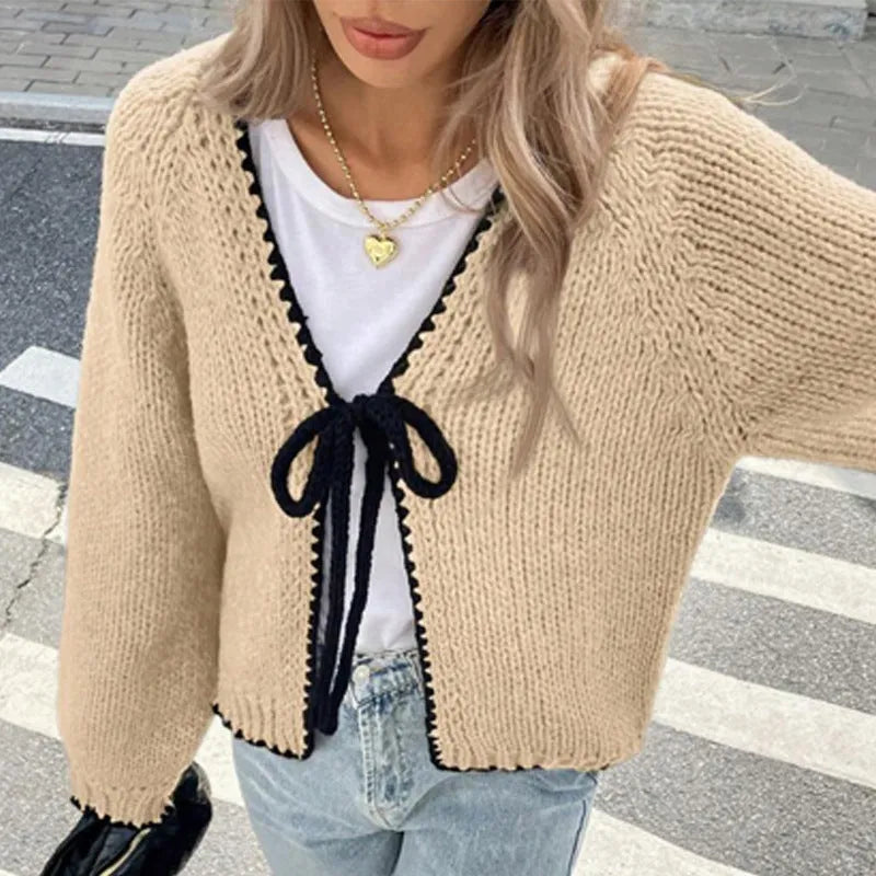 Lace-up front cardigan sweater with crocheted flower detail in solid colour