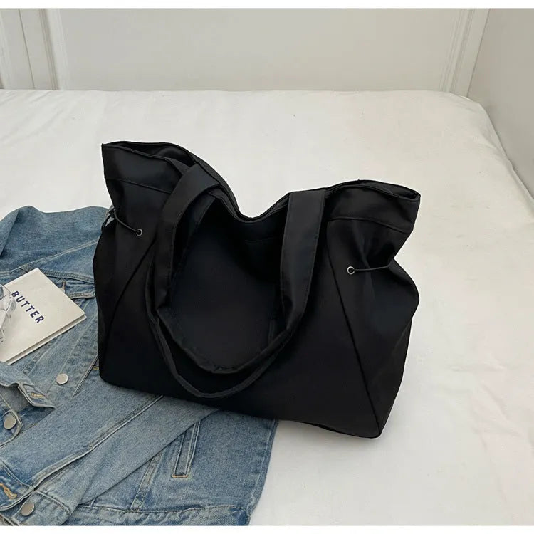 Folding Oxford cloth tote bag in multiple colour options showing compact storage design