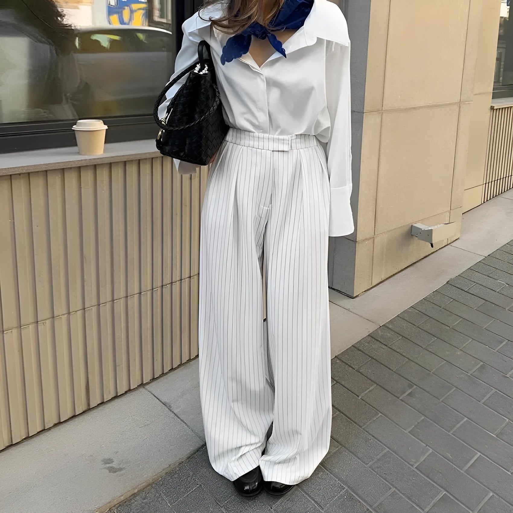 White women's wide-leg trousers with a stripe detail and zip fastening, laid flat.
