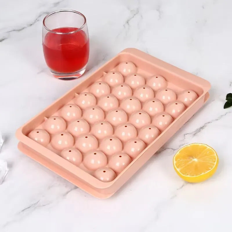 Blue silicone ice cube tray with lid showing 33 round moulds for homemade ice