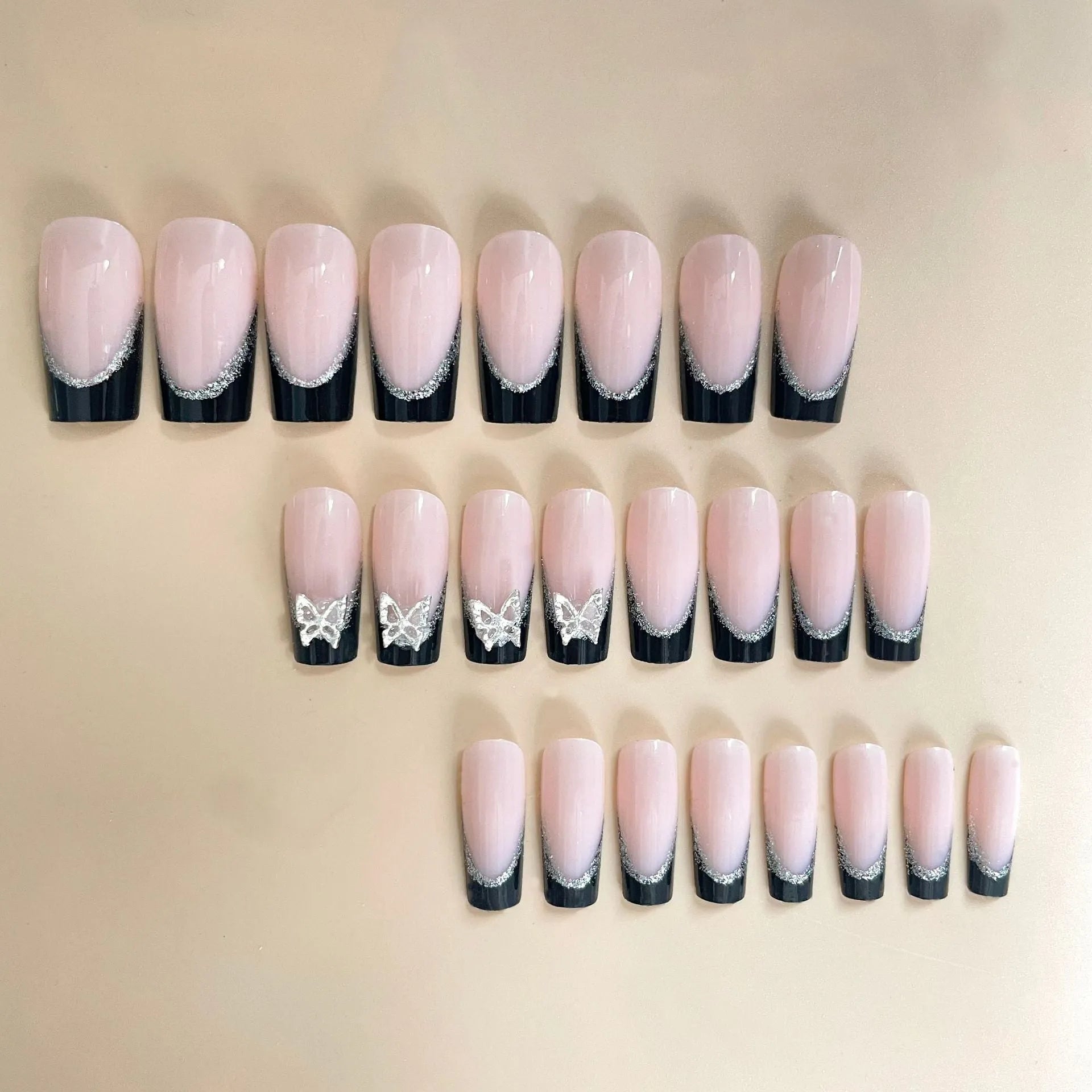 French style artificial nails with glittering butterfly pattern in medium length wearable design