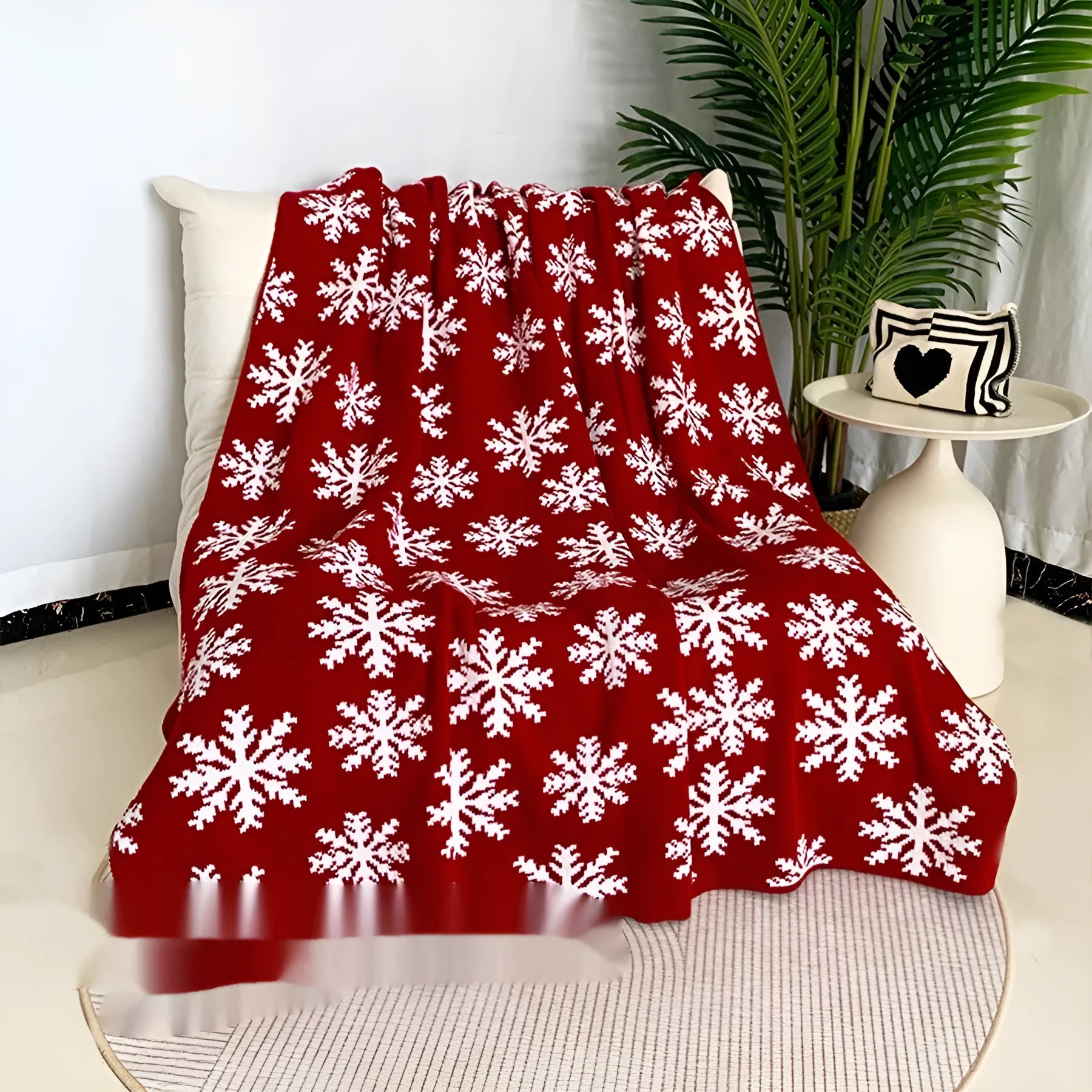 Personalised acrylic Christmas blanket with snowflake or reindeer pattern on a sofa.
