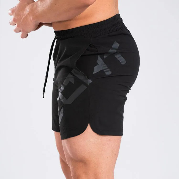Men's black knee-length quick-dry nylon running shorts laid flat, showing mid-waist and sport design.