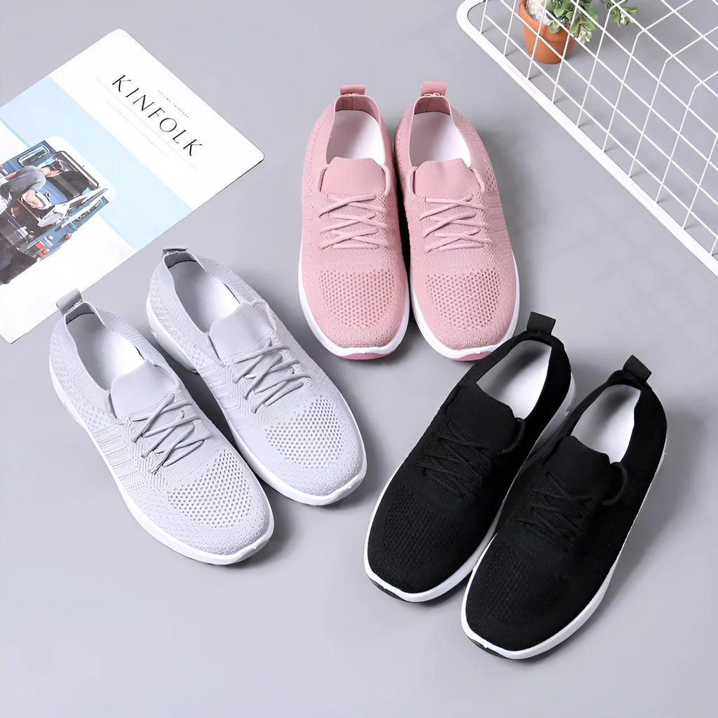 Women's solid colour casual sneaker with mesh upper, round toe, and front laces.