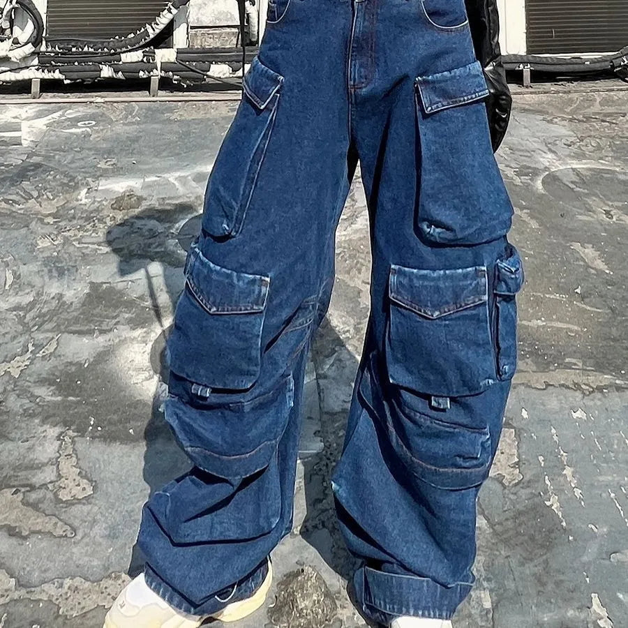 Distressed dark blue wide-leg jeans with high waist and multiple pockets on mannequin