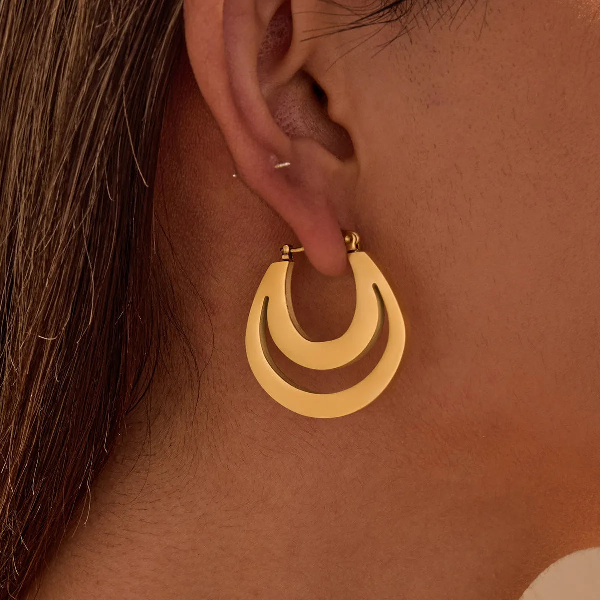 Geometric minimalist French earrings in gold and steel colours with round ring design elements