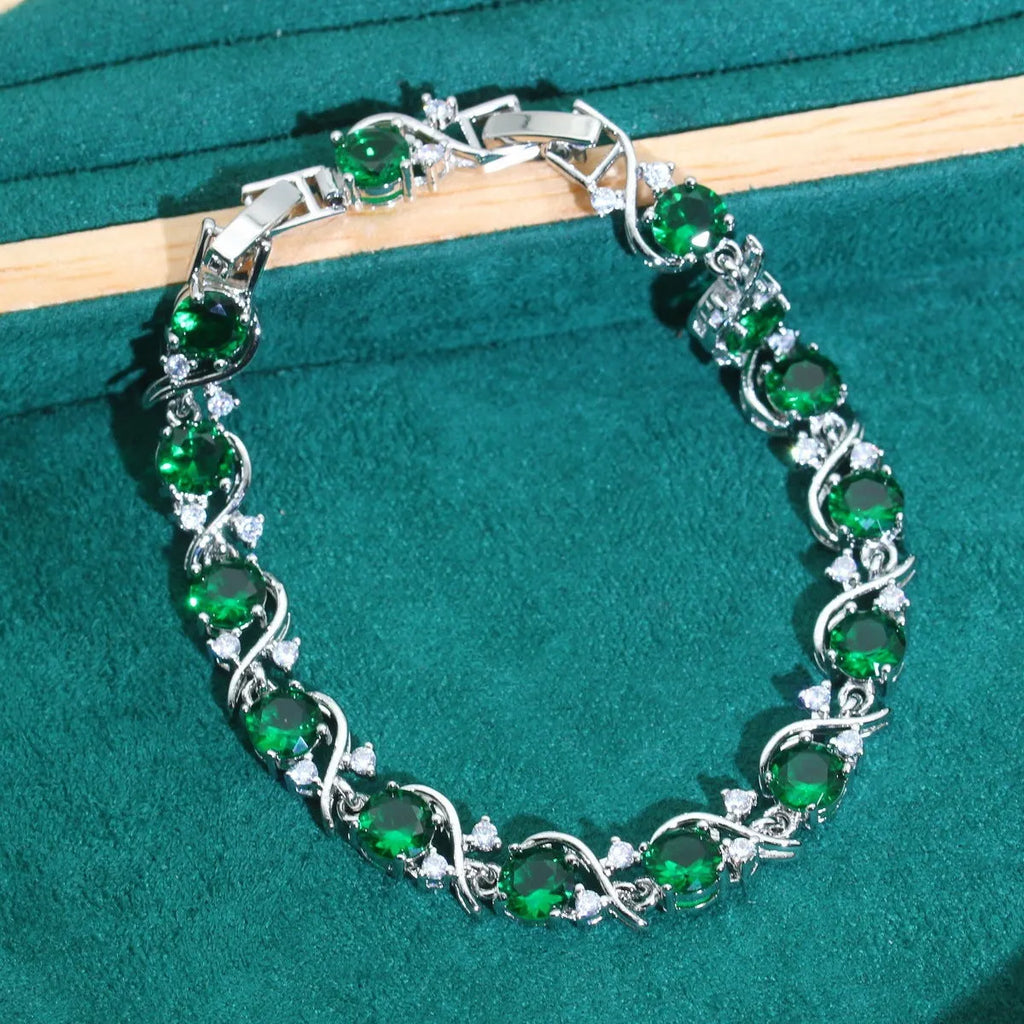 Female model wearing a golden green AAA zircon inlaid copper bracelet with a retro leaf shape design.