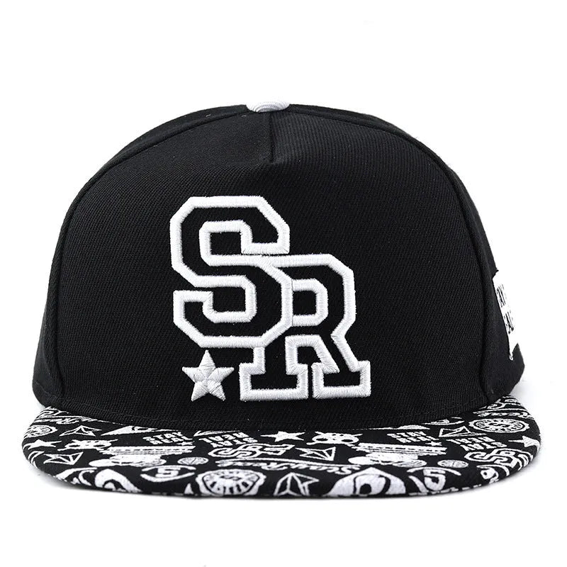 Black and white cotton baseball cap with letter embroidery on the front, showing adjustable strap.