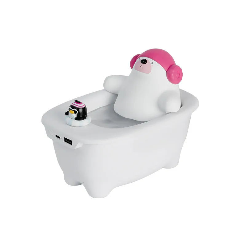 White USB air humidifier with large water tank on a desk next to a laptop.