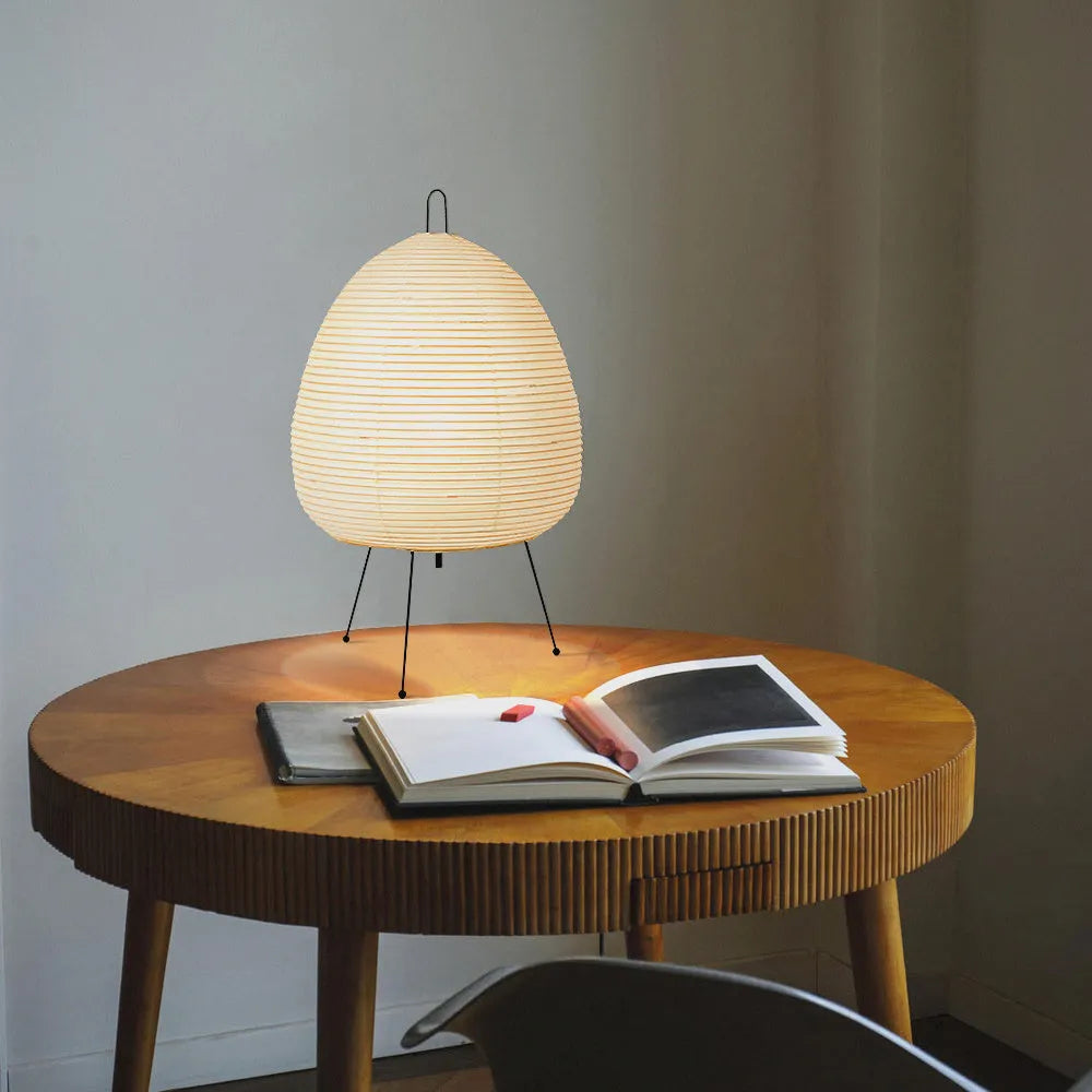 Japanese style rice paper table lamp with handmade shade and aluminium base on wooden surface