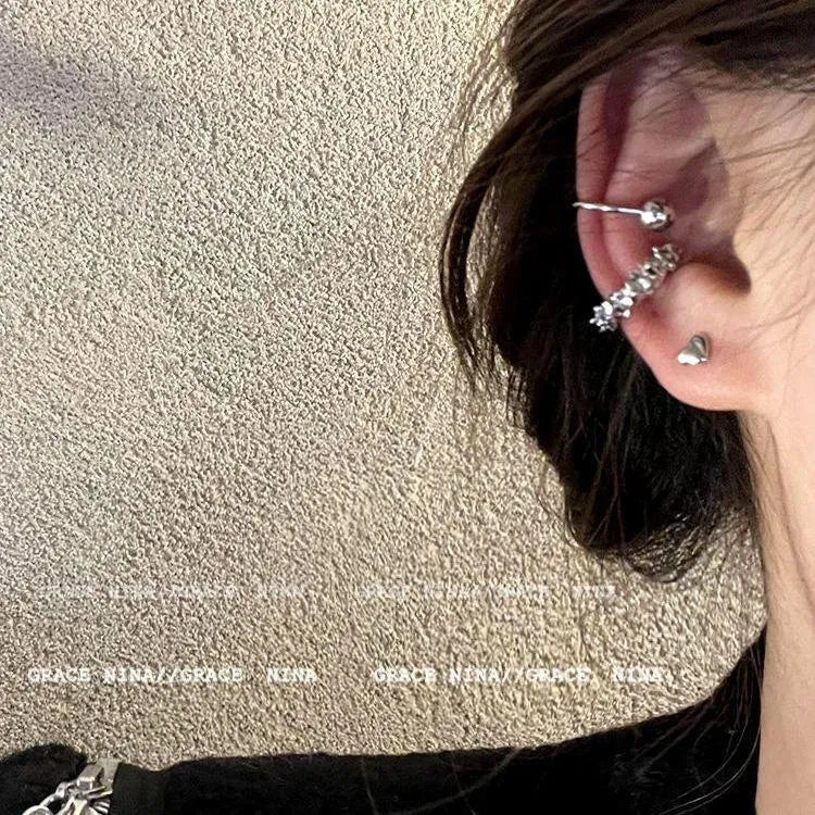 Pair of geometric-shaped alloy ear clips with a frosty finish and double clip mechanism.