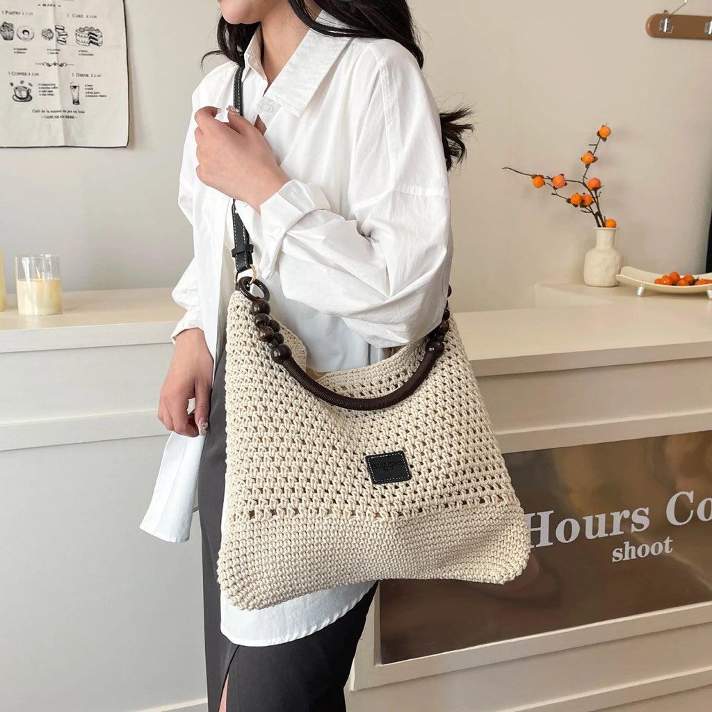Knitted bucket tote beach bag with contrast stitching and zippered interior compartment