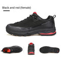 Men's low-top hiking boots in dark grey with round toe and front lace-up design on a rocky trail.