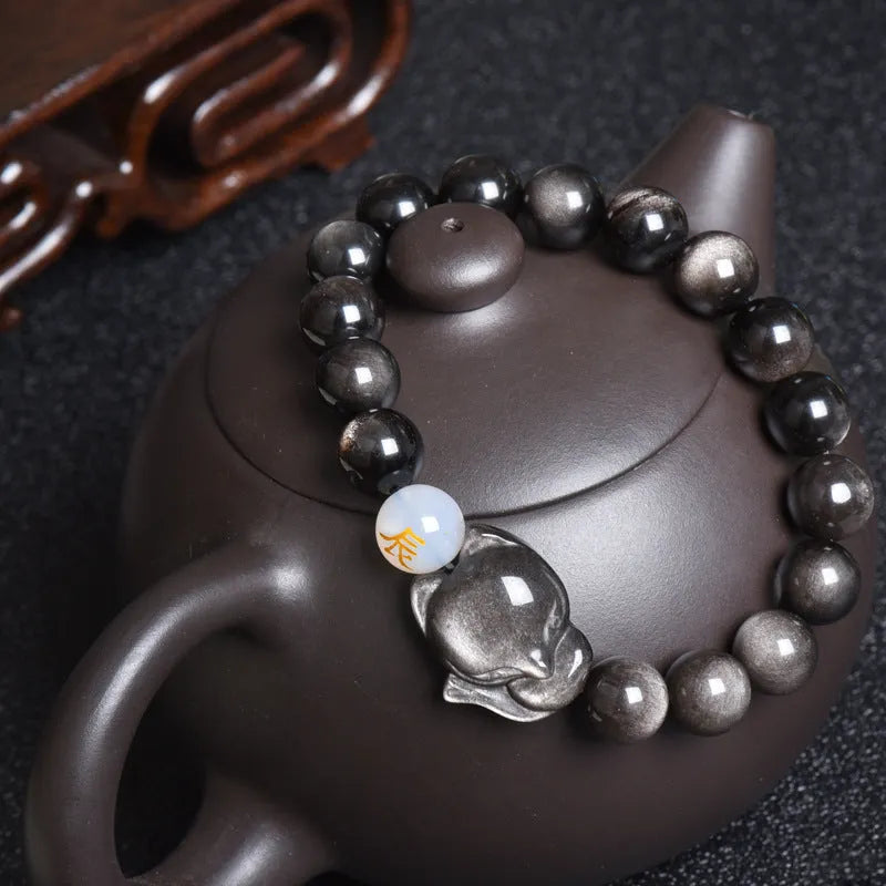 10mm obsidian zodiac bracelet on wrist showing adjustable cord closure and polished stone beads