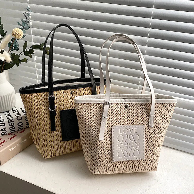 Straw woven women's shoulder bag in black with three-dimensional pockets and 27cm width