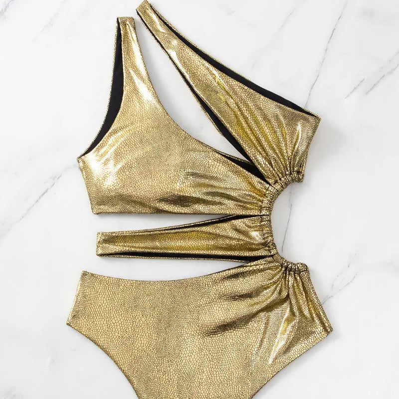 Women's gold one-piece swimsuit with backless design and spandex lining for swimming activities